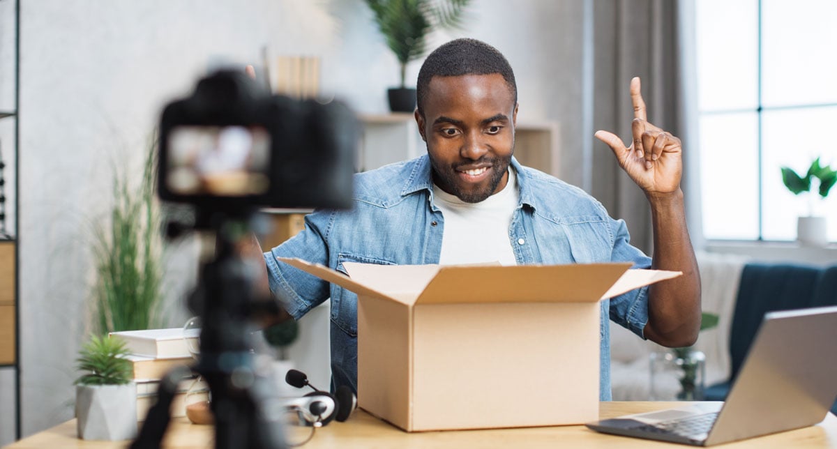 african-guy-recording-video-while-opening-box-2024-12-12-02-24-29-utc