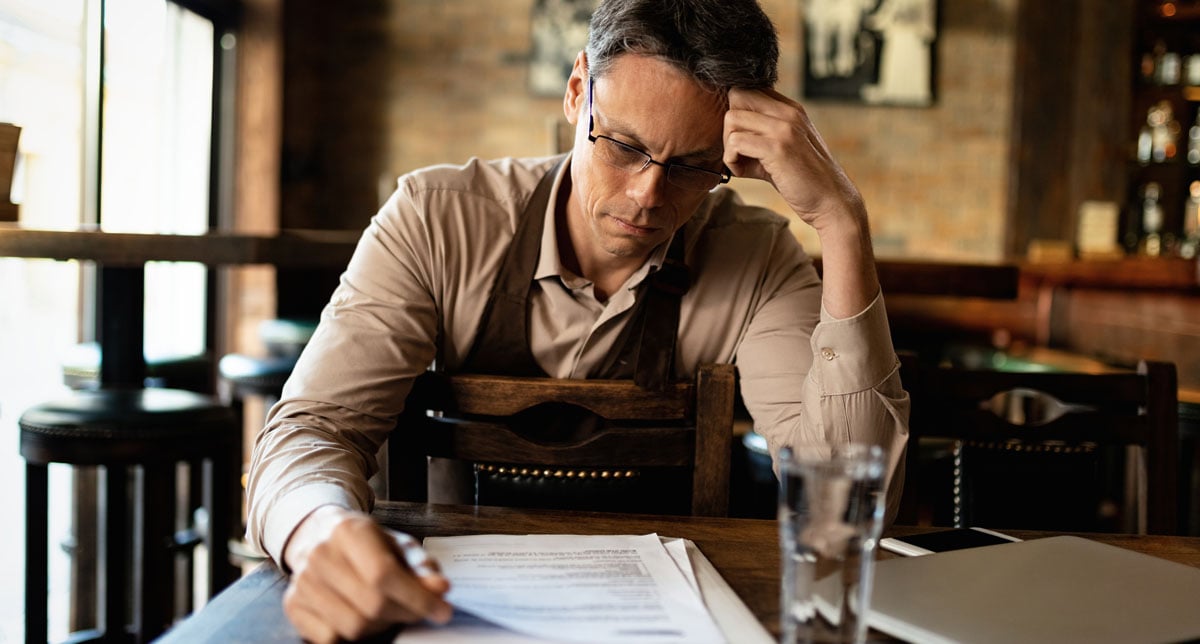 bar-owner-reading-reports-and-going-through-paperw-2024-12-13-18-01-18-utc