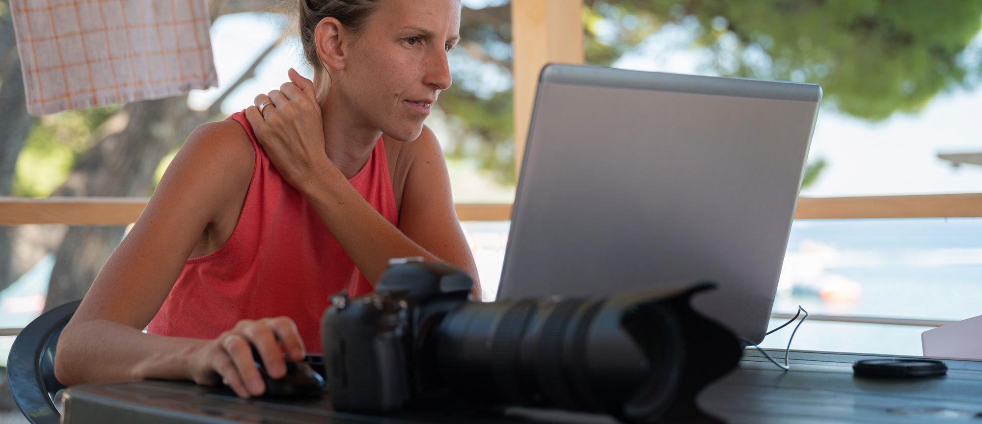 young-female-photographer-editing-phots-on-her-lap-2025-02-19-11-07-07-utc